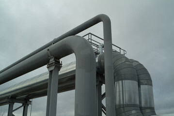 metal pipes of the pipeline on the background of the gray sky
