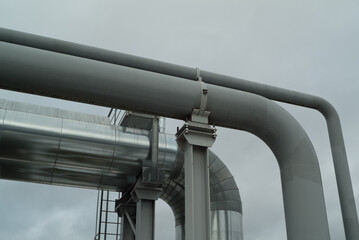 metal pipes of the pipeline on the background of the gray sky