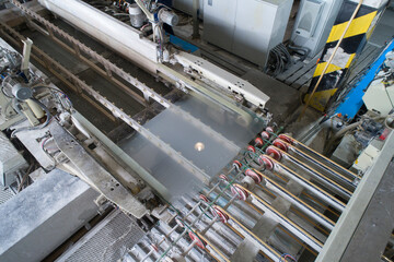 Modern equipment for glass processing. Conveyor line on which glass is cut and polished. 