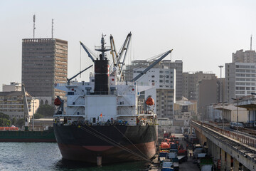 Big cargo ship moored in the port of Dakar, Senegal. Bulk carrier vessel. - obrazy, fototapety, plakaty