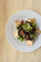 Green and purple lettuce salad. Arugula and pieces of casabe. Healthy food.
