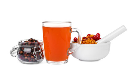 Glass cup of immunity boosting tea and ingredients on white background