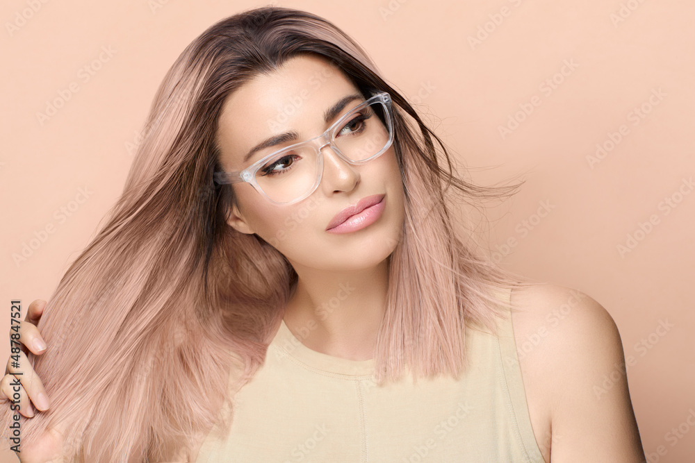 Wall mural women eyewear. beautiful young woman in fashionable clear glasses posing in studio. fashion eyewear 