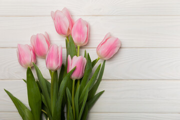 Pink tulips on a white wooden background.Side view. Spring bouquet.Holiday concept.Women's day, Valentine's day,Easter, birthday.Copy space.