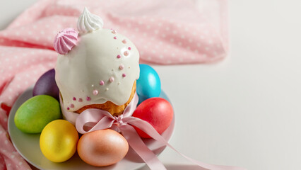 Easter cake, the traditional multi-colored eggs and pink cloth on the holiday table