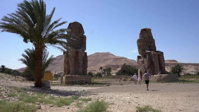 Colossi of Memnon in Luxor at sunrise front view tourist attraction