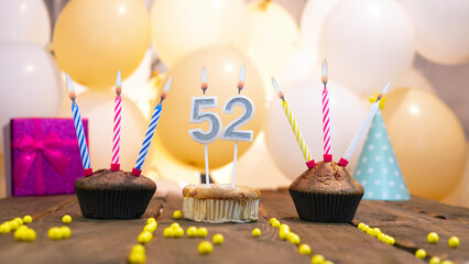 Beautiful birthday card for a woman with the number 52 in a cupcake against the background of...
