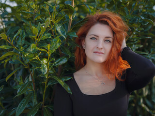 Portrait of beautiful young woman walking in an autumn park