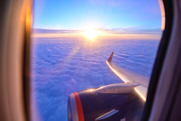beautiful sunset through the plane window. the wing of the aircraft. view of the clouds from the plane
