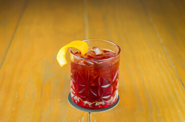 Classic Negroni Cocktail in a retro glass with ice and orange peel