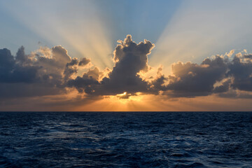 Naklejka na ściany i meble Beautiful seascape - waves and sky with clouds with beautiful lighting. Golden hour.