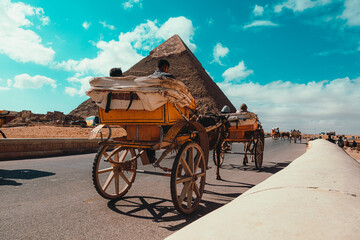 Cairo Egypt December 2021 Rear view of a horse chariot riding around the great pyramids of giza. Popular way of getting around the area for tourists
