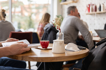 People seated at tables in a cafe