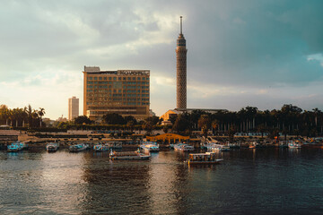 Cairo Egypt December 2021 View of the Nile river at sunrise, and the Cairo tower in the distance. Bright orange colors on a warm day