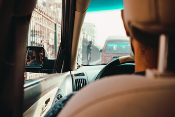 Inside view of a car driving down the busy streets of cairo, egypt. Unrecognizable driver and unrecongizable vehicle stuck in a traffic jam