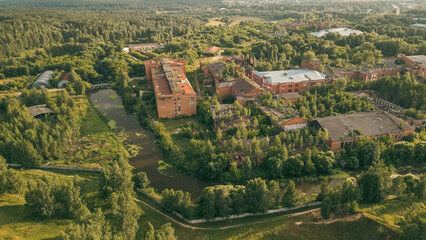 Аerial view of an old textile factory surrounded by a river, at dawn. Vladimir region, Russia