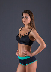 Obraz premium beautiful caucasian girl sportswoman goes in for sports. girl doing exercises