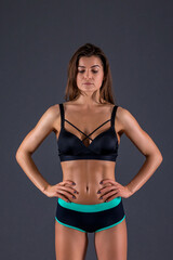 Fototapeta premium beautiful caucasian girl sportswoman goes in for sports. girl doing exercises