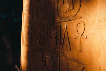 Close up of ancient egyptian hieroglyph symbols as seen on a yellow sandy wall in egyptian ruins....