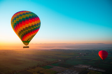 Amazing view of a bright vibrant baloon at sunrise. Balloon rides in luxor, view of egypt. Famous in cappadoccia as well, thrill of the ride popular with tourists