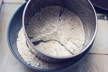 Strained flour for muffins preparation.