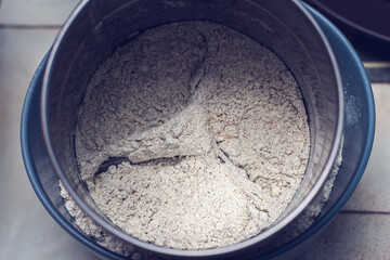 Strained flour for muffins preparation.