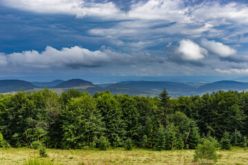 Amazing landscape at the mountain top. Panoramic view at mountain valleys lit by sun