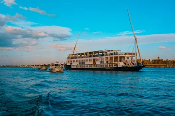 Foto op Plexiglas Luxor Egypt January 2022 Cruise ship cruising down the river nile, around the luxor area. Famous egyptian tourist destination for travelers © Antonio
