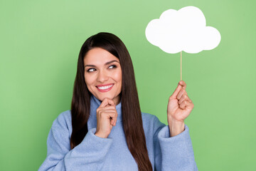 Photo of optimistic mature brunette lady look clouds wear blue turtleneck isolated on green color background