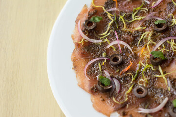 Sliced ​​fish. Fish carpaccio with salad, olives and fennel
