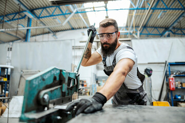 Worker doing metal jobs in the workshop.