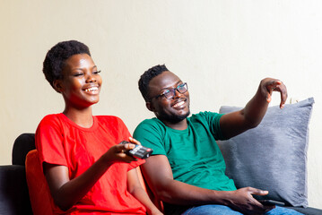 beautiful happy young couple watching movie on small screen at home.