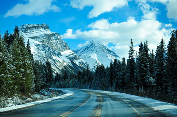 icy wet mountain road in the rocky  mountains of Banff National Park, Alberta, Canada