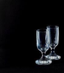 Two glasses isolated on a black background