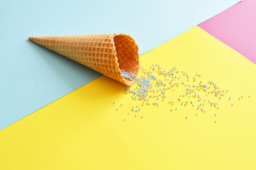 waffle cup with bright sprinkles and multicolored festive background