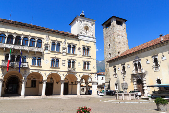 Palace Palazzo dei Rettori with arcade and clock tower at city square Piazza del Duomo in historic city of Belluno, Italy