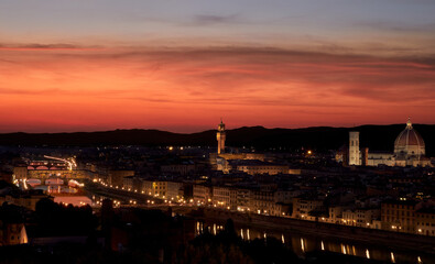 Panoramic view over Florence from the square at sunset with the red sky