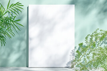 Blank white drawing canvas on mint colored surface with palm leaves, home plants and soft floral shadows. Spring Summer Typography, To do list. Ecodesign.