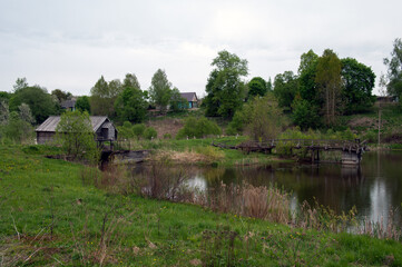 Fototapeta na wymiar Watermill on the Ovstuzhenka River, Ovstug village, Zhukovka district, Bryansk region, Russia, May 10, 2014