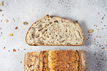 Fresh homemade bread (slice) from whole grain sourdough flour with the addition of bran, seeds...