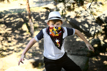 boy in a cowboy bandana on the background of the forest
