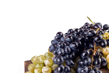 Assortment of ripe sweet grapes in wooden bunch on white background. close up image with copy space