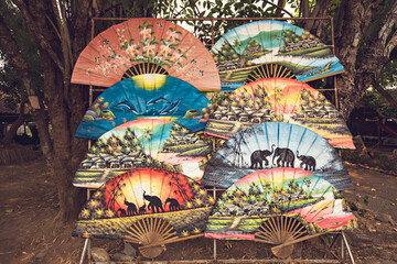 Traditional Thai colorful fans for sale in the workshop in Chiang Mai, Thailand