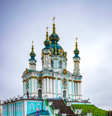 Fototapeta na wymiar Beautiful St. Andrews Cathedral with gold laden decorations on the domes in Kiev