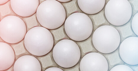 Fresh eggs in carton box, background, top view flat lay.