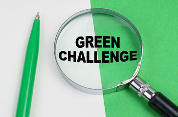 On a white-green background lies a pen and a magnifying glass, inside which is the inscription - Green challenge