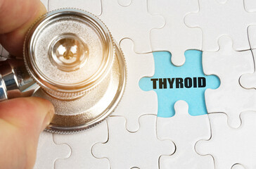 On puzzles a hand with a stethoscope, on a blue background the inscription - THYROID