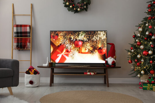 Stylish living room interior with modern TV and Christmas decor