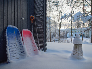 After a snowfall at a house in Europe: a lot of snow, household items under snow, Christmas lantern.