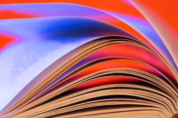 Open book close up macro photo. Wisdom and education concept.Love reading. Retro neon light 90s